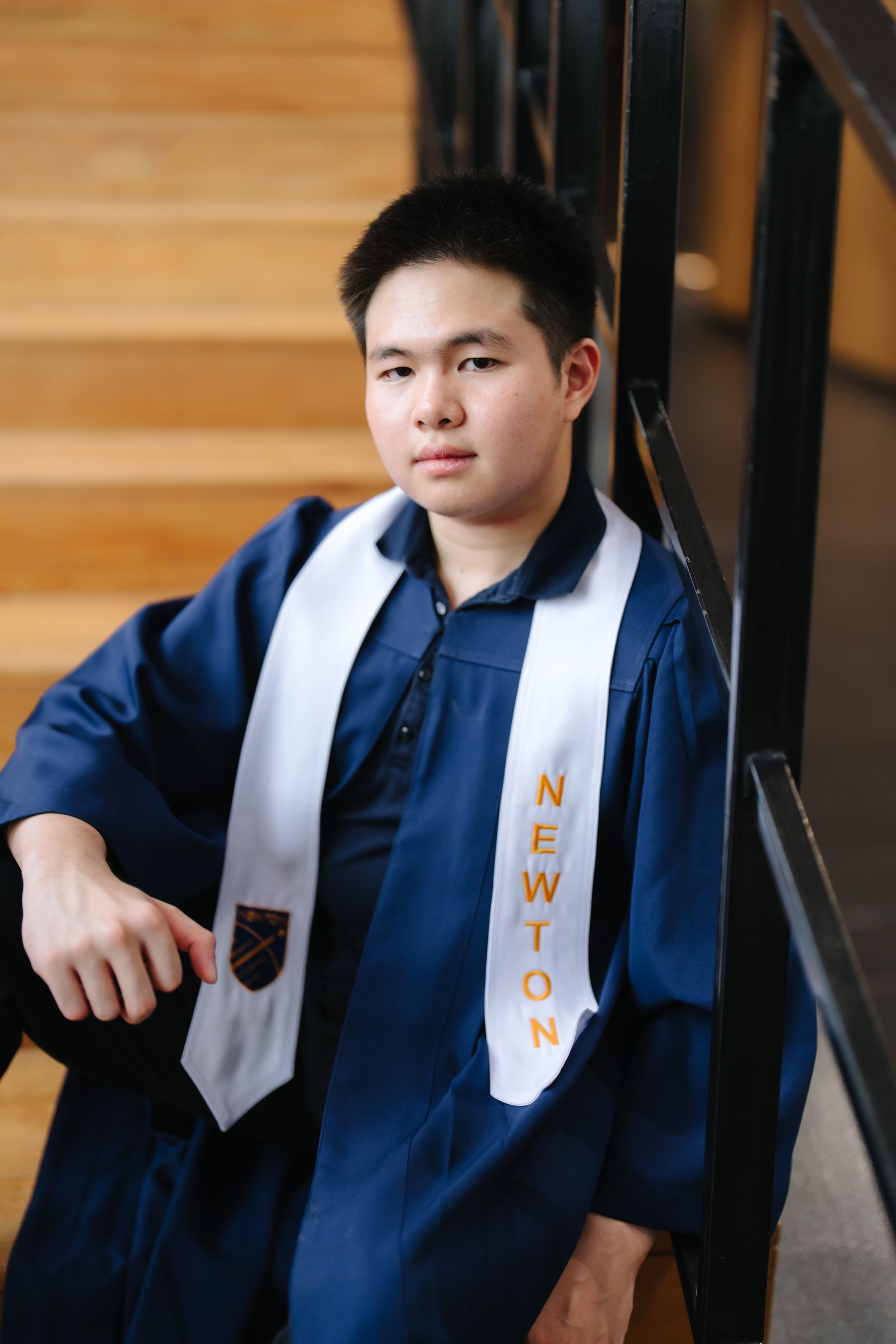 Richy Phansukhumthana seated beside a staircase